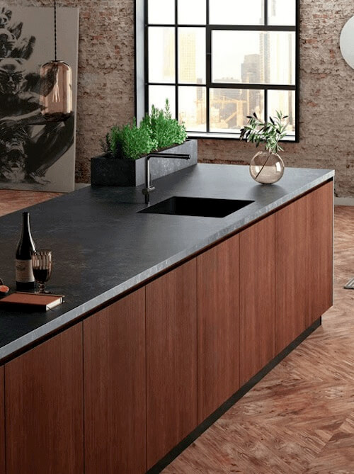 Black countertop and sink island with medium wood sides available in Abbotsford